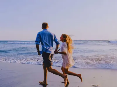 Man and woman running on a beach
