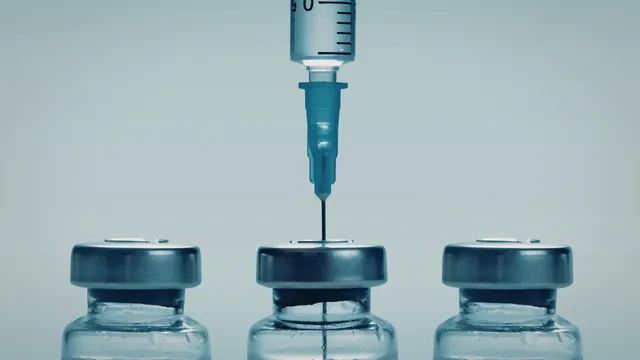 Syringe drawing a vitamin injection from a vial